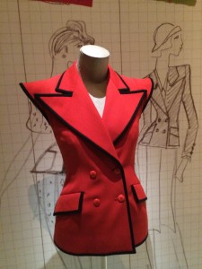 Sleeveless tailored jacket with exaggerated shoulders.