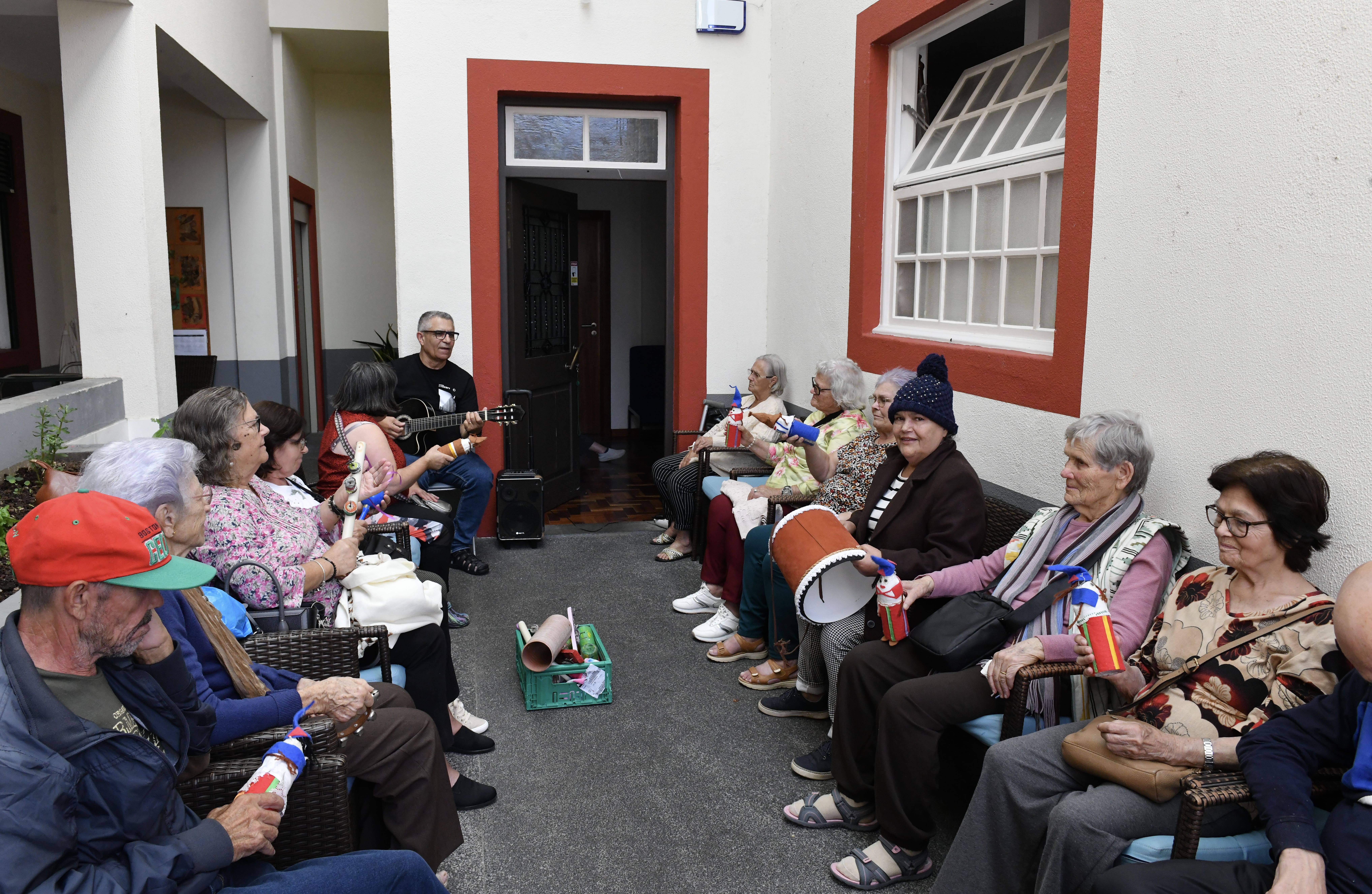 Idosos do Centro de Dia da Casa São José numa atividade com o professor de música.